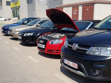 Various vehicles being prepared for import test Vehicles in a row